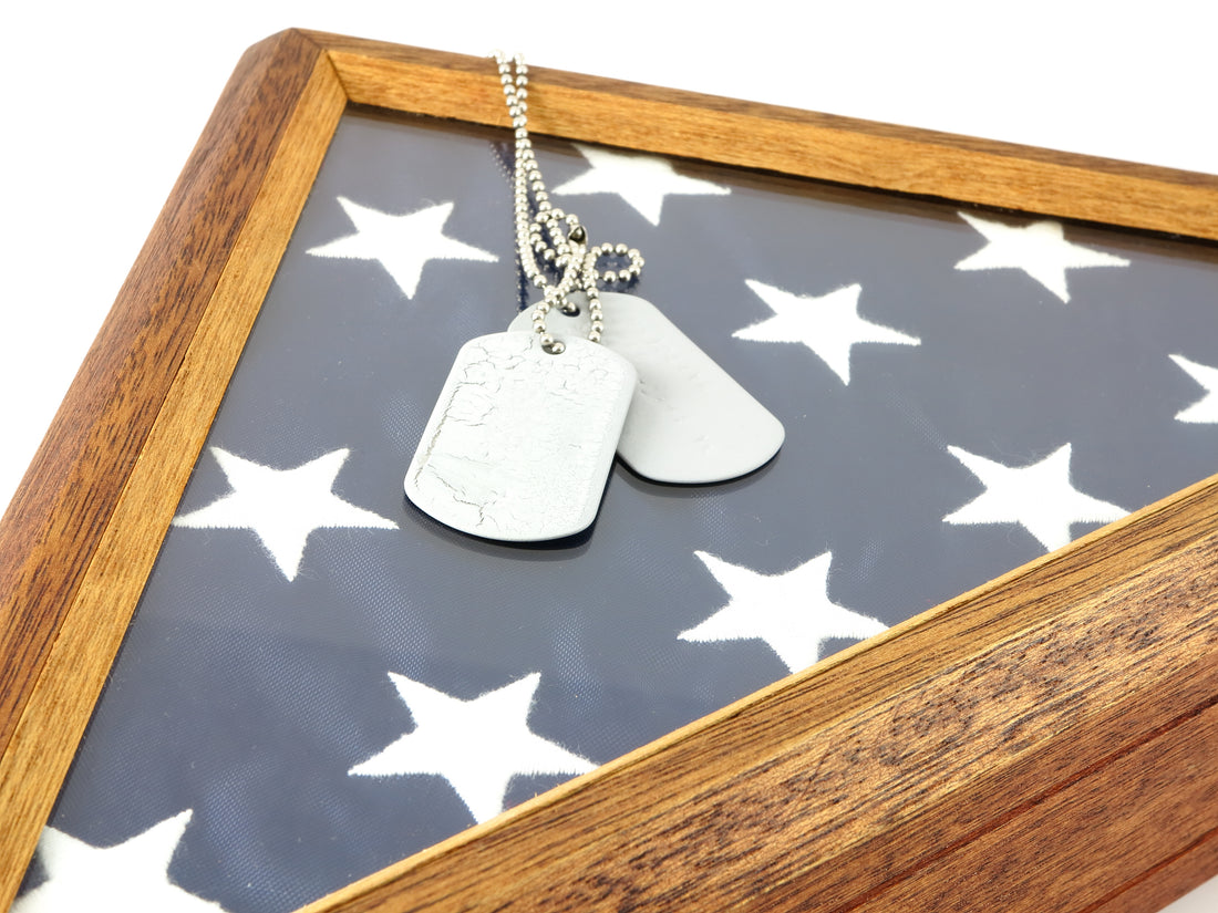 Beautiful light wooden flag case with an American flag in it laying on its back with a pair of dog tags laying on top.